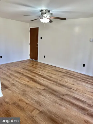 a view of a room with a ceiling fan