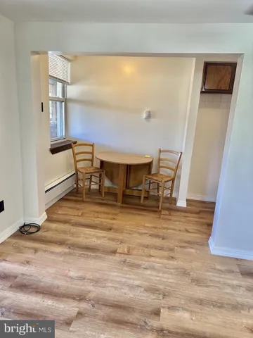 a room with wooden floor and furniture
