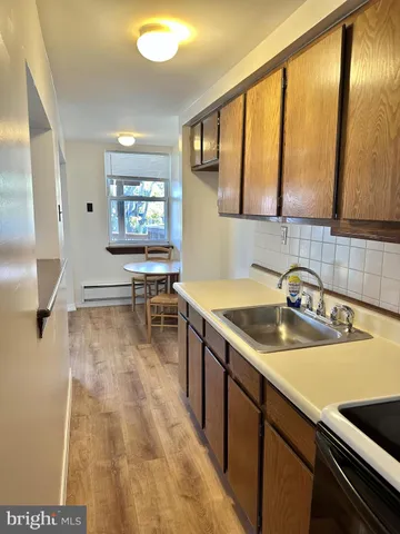a kitchen with a sink and a stove top oven