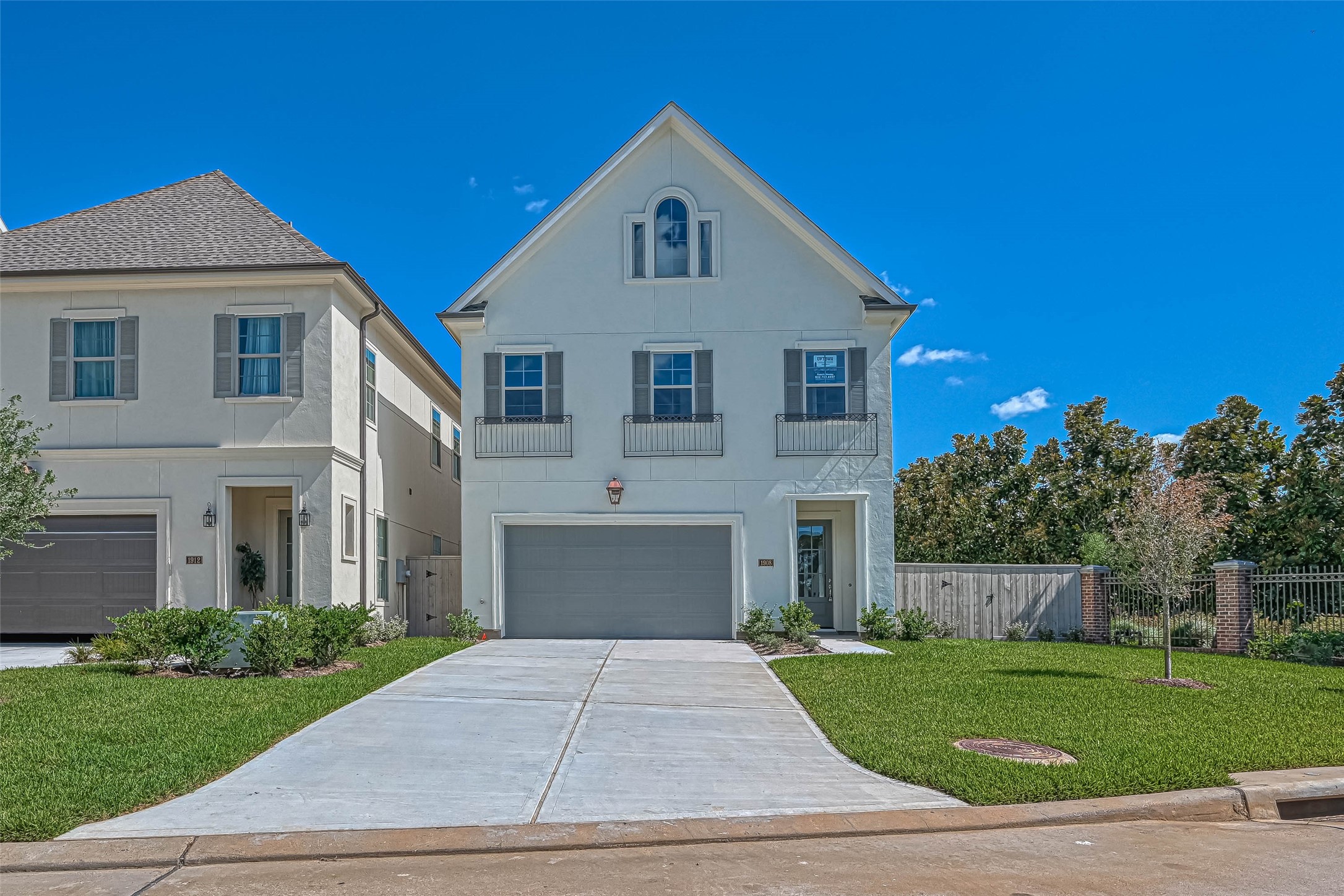 a front view of a house with a yard and trees