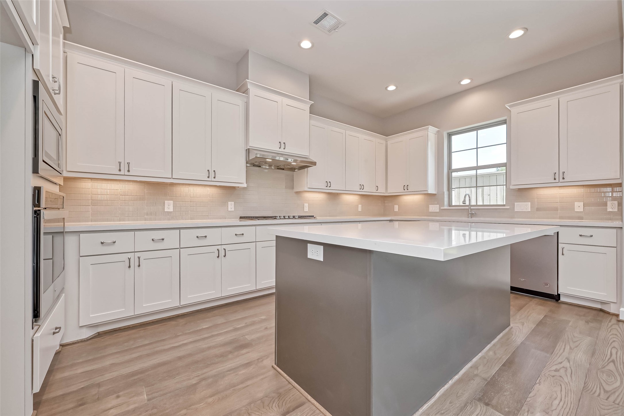 1908 Carrollton Mill Drive Spring, TX 77380 - Photo 14 of 40 a kitchen with kitchen island white cabinets appliances and a sink