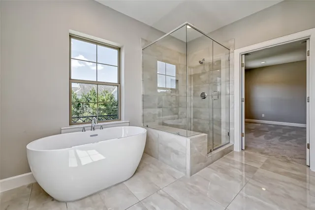 a bathroom with a bathtub and a shower