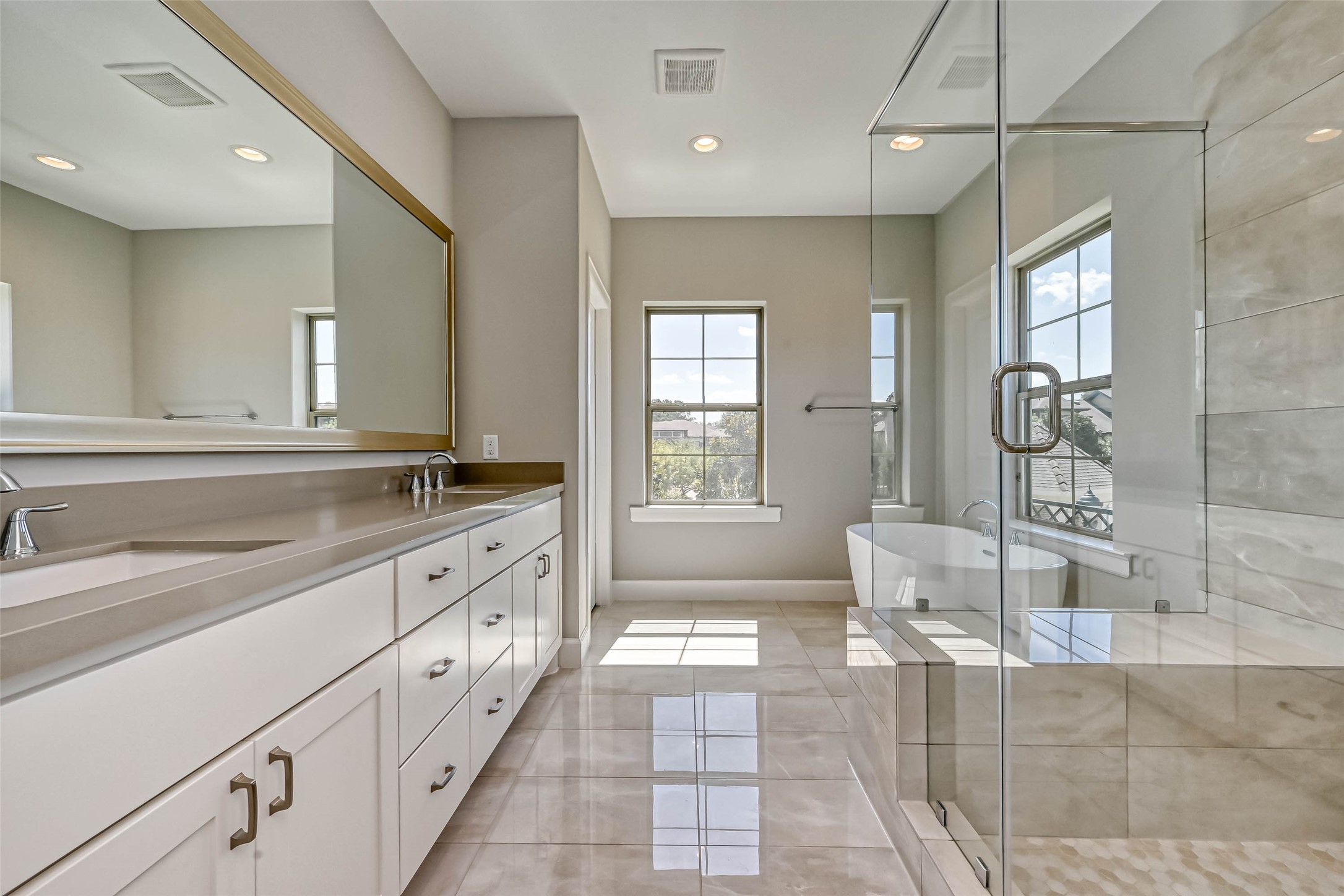 1908 Carrollton Mill Drive Spring, TX 77380 - Photo 29 of 40 a large bathroom with a granite countertop tub a double vanity sink a mirror and a shower