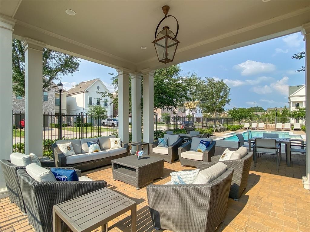 1908 Carrollton Mill Drive Spring, TX 77380 - Photo 38 of 40 a living room with patio furniture and a floor to ceiling window