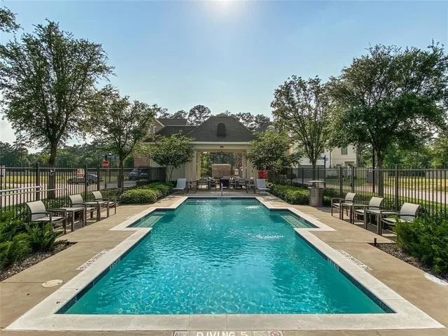 a view of a house with swimming pool and sitting area
