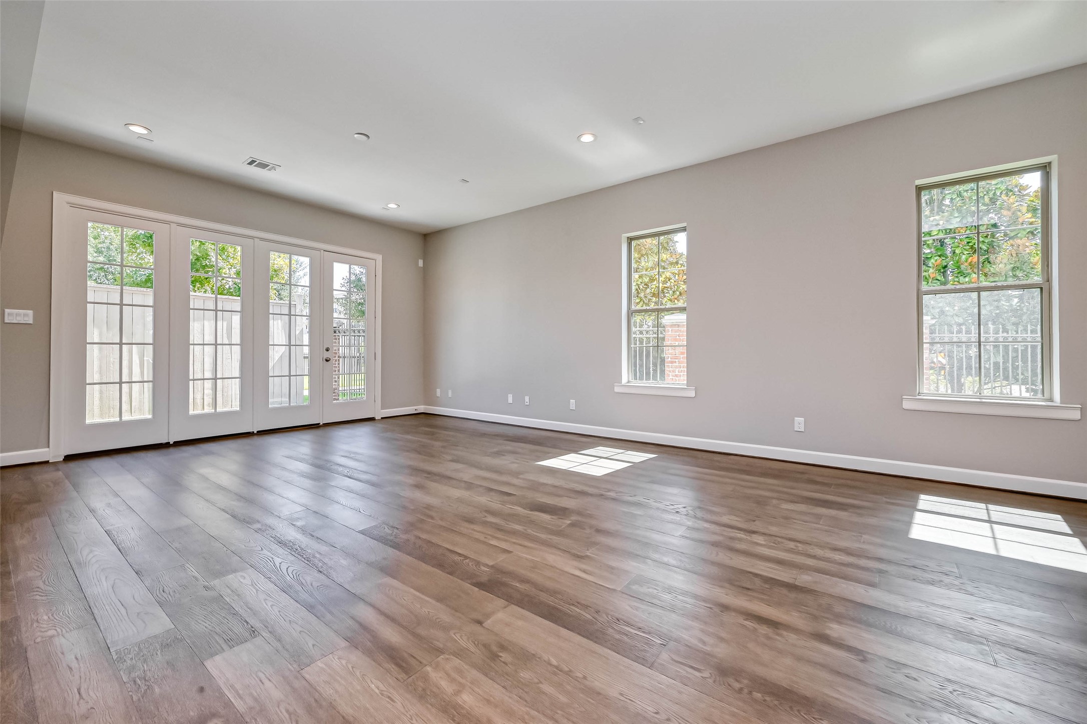 1908 Carrollton Mill Drive Spring, TX 77380 - Photo 6 of 40 an empty room with wooden floor and windows