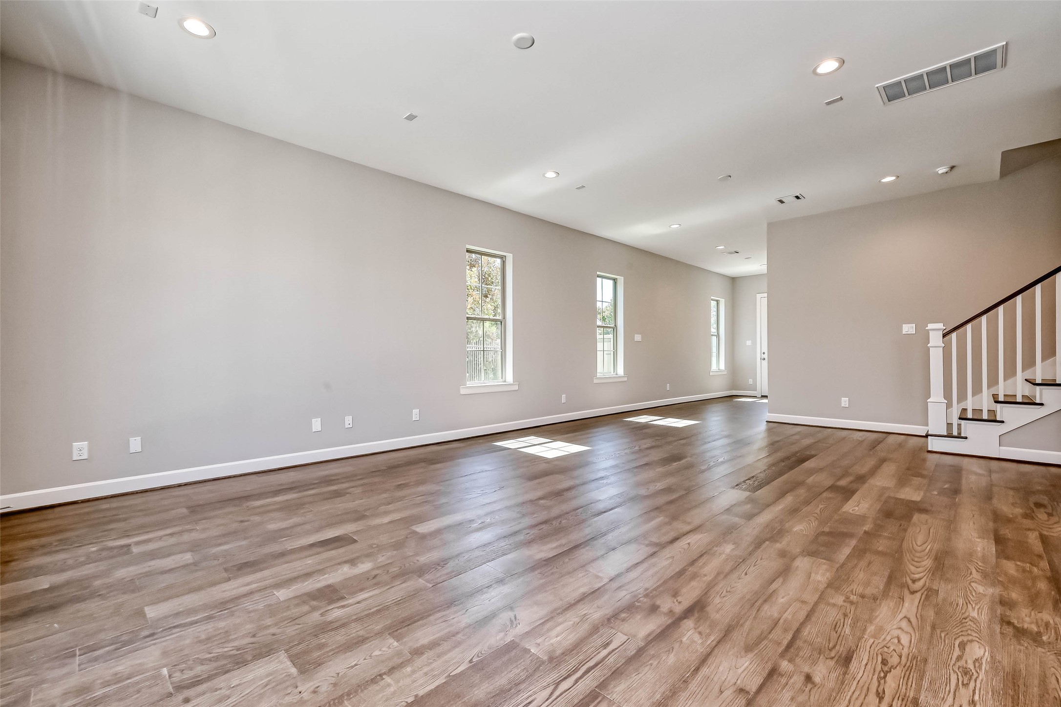 1908 Carrollton Mill Drive Spring, TX 77380 - Photo 7 of 40 an empty room with wooden floor and windows