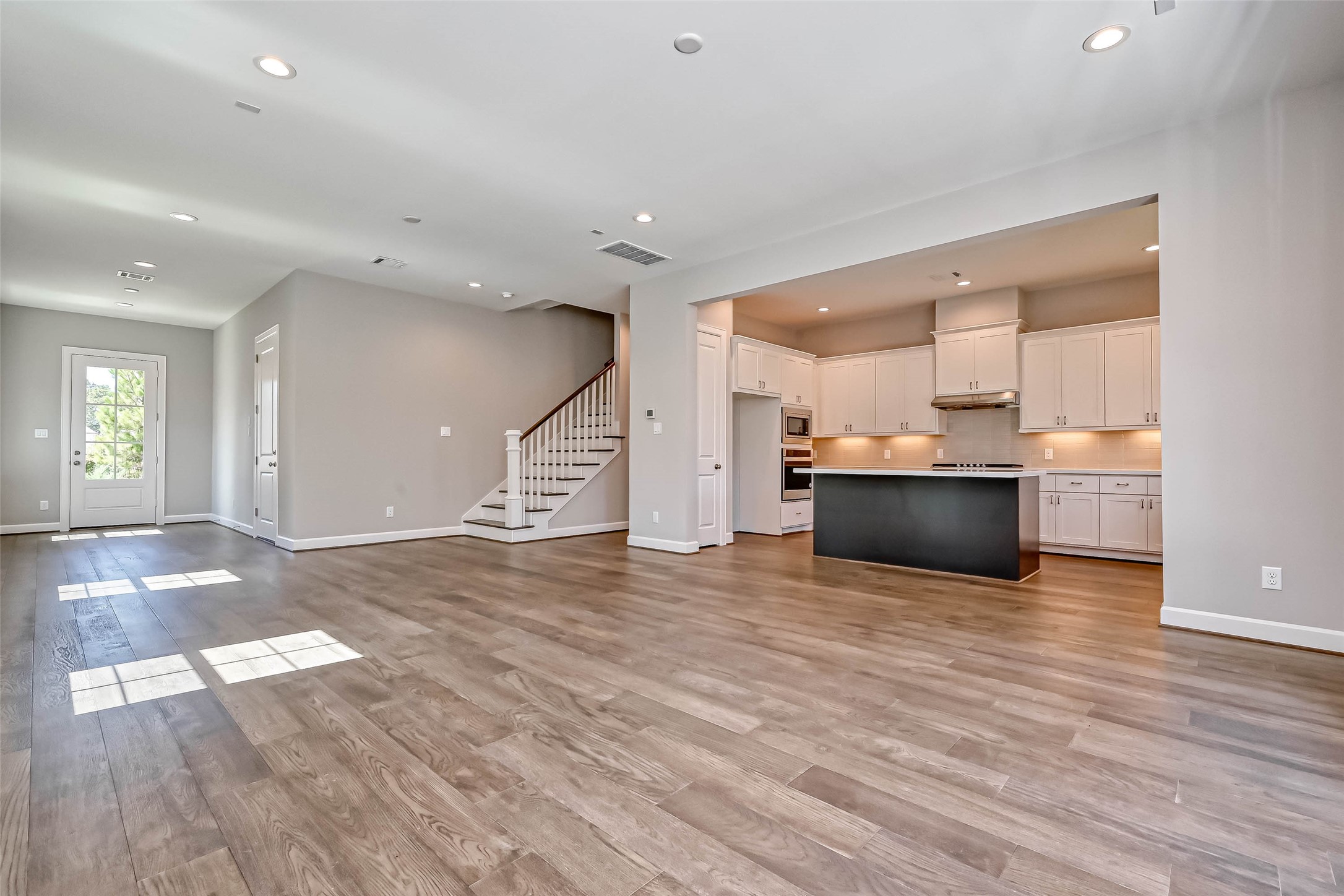1908 Carrollton Mill Drive Spring, TX 77380 - Photo 8 of 40 a view of kitchen and empty room with wooden floor