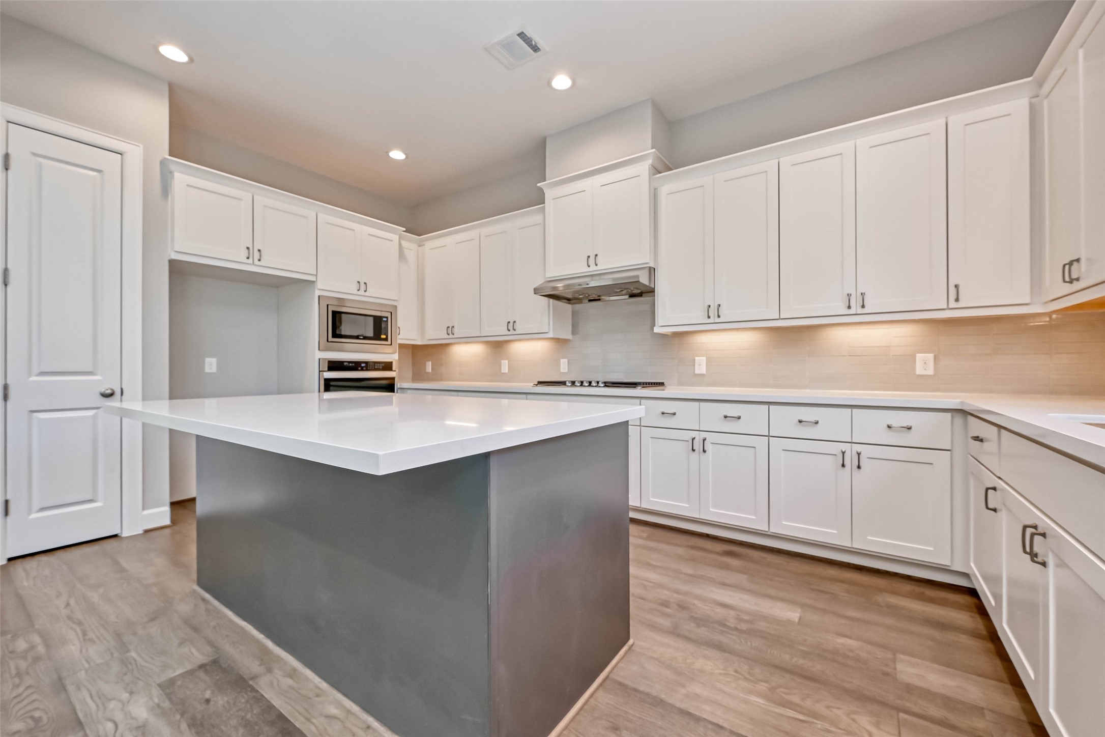 1908 Carrollton Mill Drive Spring, TX 77380 - Photo 10 of 40 a kitchen with kitchen island white cabinets appliances and a window