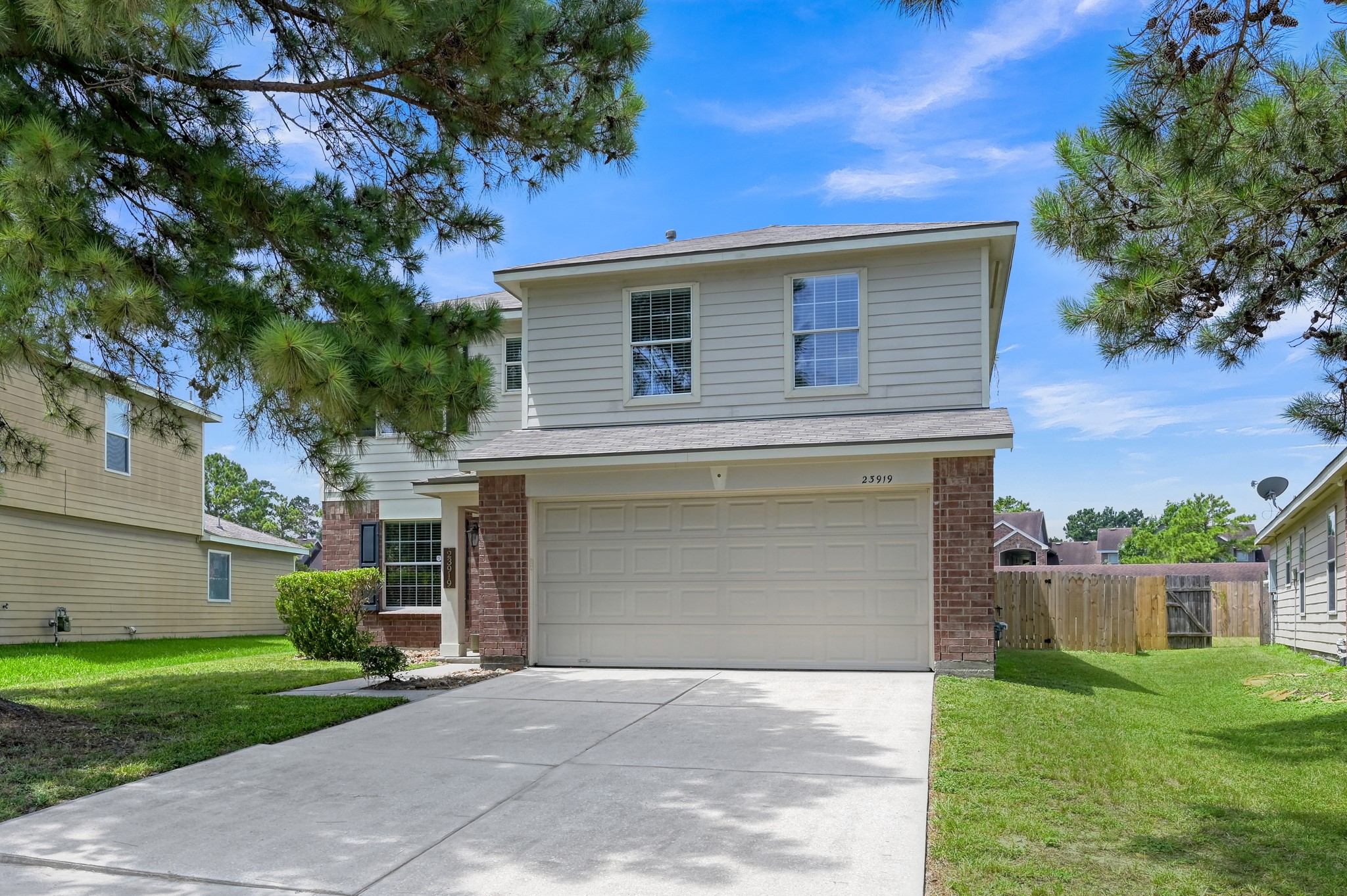 23919 Kingbriar Drive Spring, TX 77373 - Photo 2 of 33 The spacious driveway, attached two-car garage, and well-maintained exterior create a warm first impression.