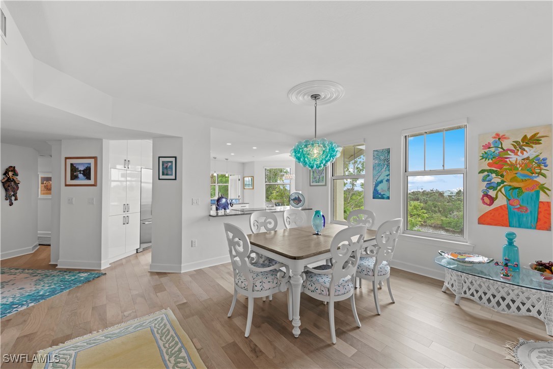 2605 Wulfert Road, Unit 5 Sanibel, FL 33957 - Photo 13 of 44 a view of a dining room with furniture and chandelier