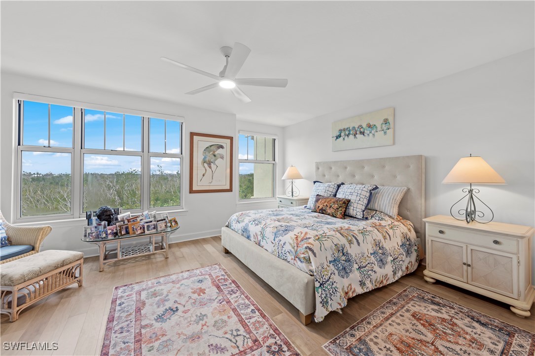 2605 Wulfert Road, Unit 5 Sanibel, FL 33957 - Photo 18 of 44 a bedroom with a large bed and a couch