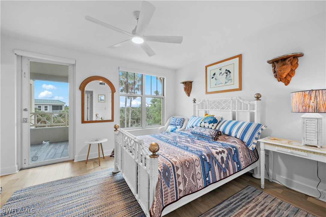 2605 Wulfert Road, Unit 5 Sanibel, FL 33957 - Photo 21 of 44 a bedroom with a bed a mirror and windows
