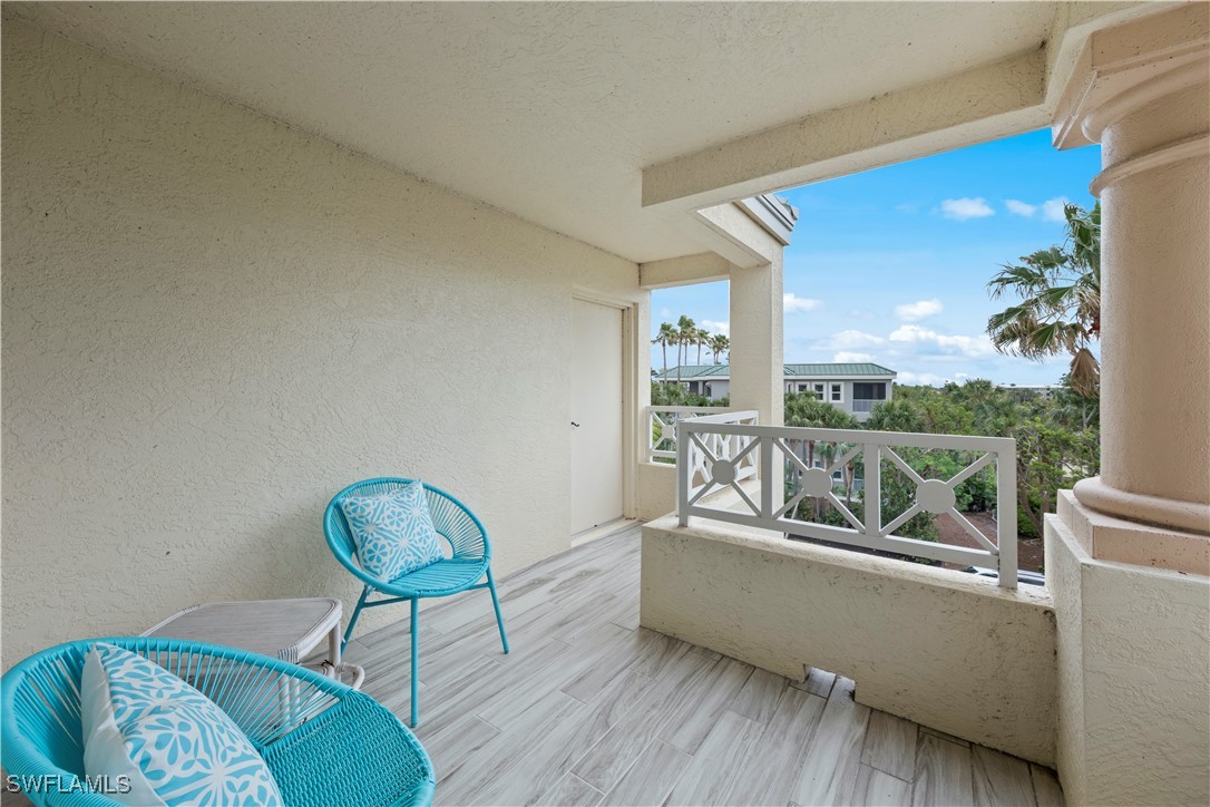 2605 Wulfert Road, Unit 5 Sanibel, FL 33957 - Photo 24 of 44 a living room with furniture and a floor to ceiling window