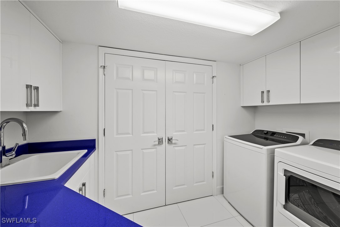 2605 Wulfert Road, Unit 5 Sanibel, FL 33957 - Photo 29 of 44 a kitchen with white cabinets and white appliances