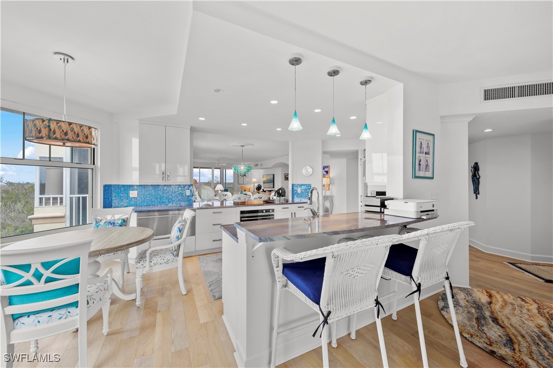 2605 Wulfert Road, Unit 5 Sanibel, FL 33957 - Photo 3 of 44 a kitchen with a dining table chairs and counter space