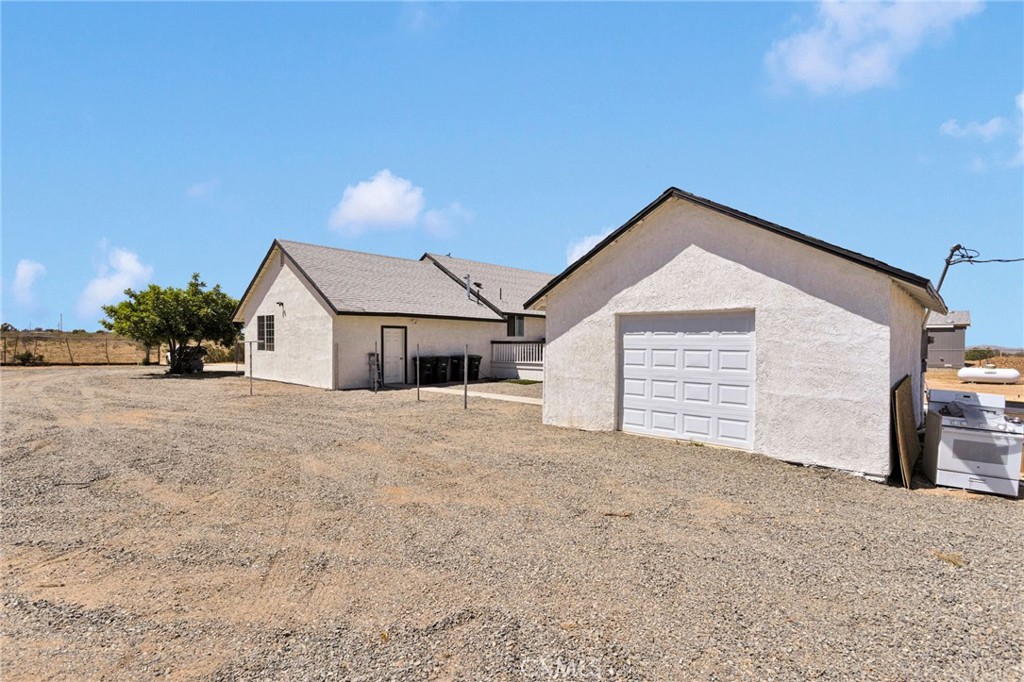 8038 Begonia Road Phelan, CA 92371 - Photo 39 of 49 a view of a house with a yard and garage
