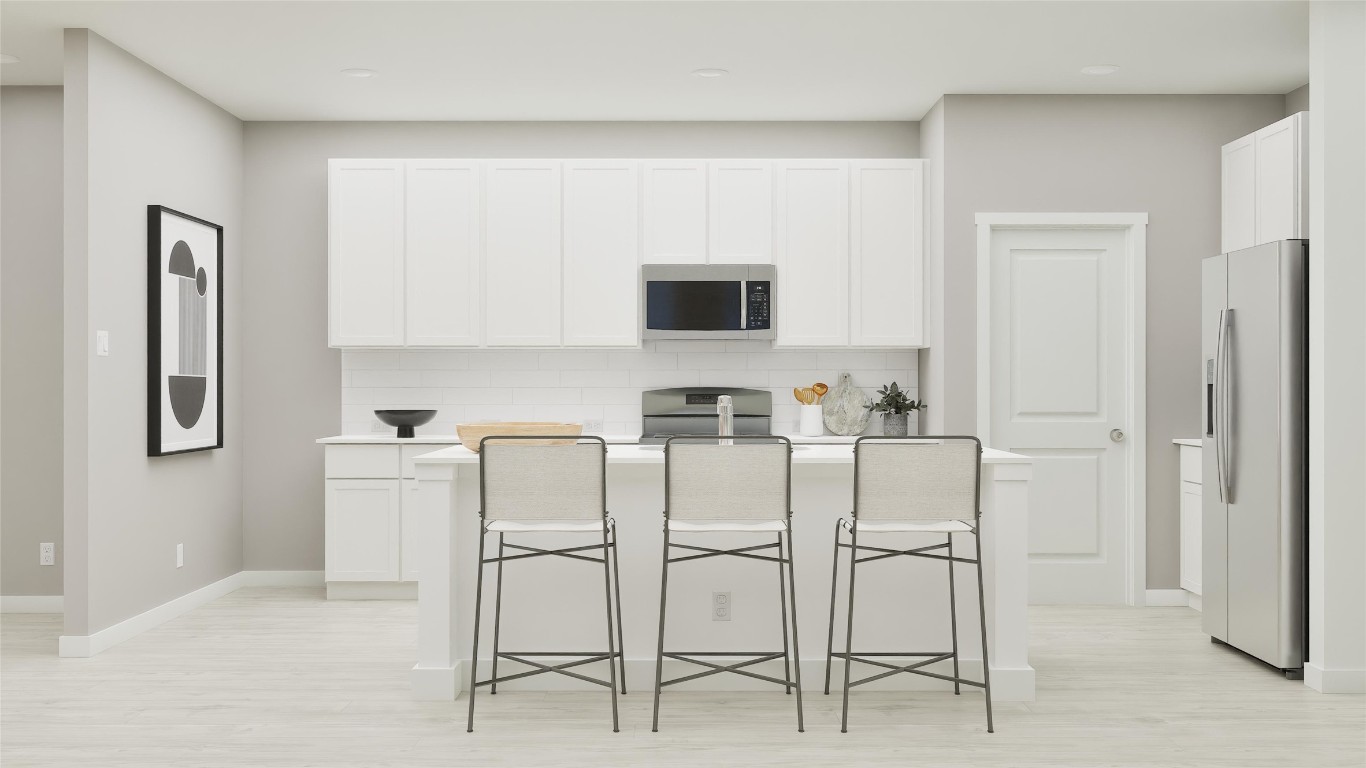 13312 Winton Drive Elgin, TX 78621 - Photo 26 of 35 a white kitchen with stainless steel appliances granite countertop a stove top oven a sink a refrigerator with white cabinets and stainless steel appliances