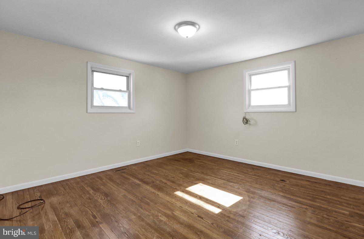 2326 Fairview Street Reading, PA 19609 - Photo 12 of 27 an empty room with wooden floor and windows