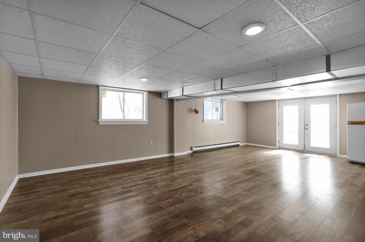 2326 Fairview Street Reading, PA 19609 - Photo 19 of 27 an empty room with wooden floor and windows