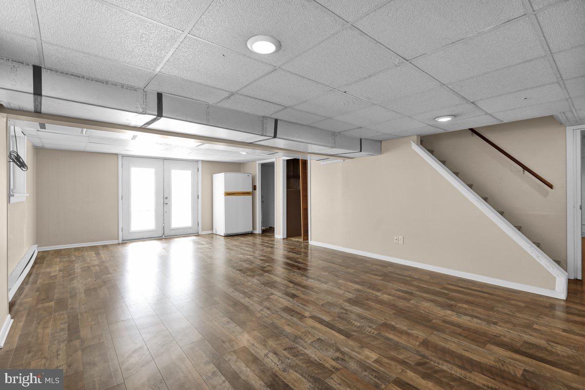 2326 Fairview Street Reading, PA 19609 - Photo 20 of 27 a view of an empty room with wooden floor and a window