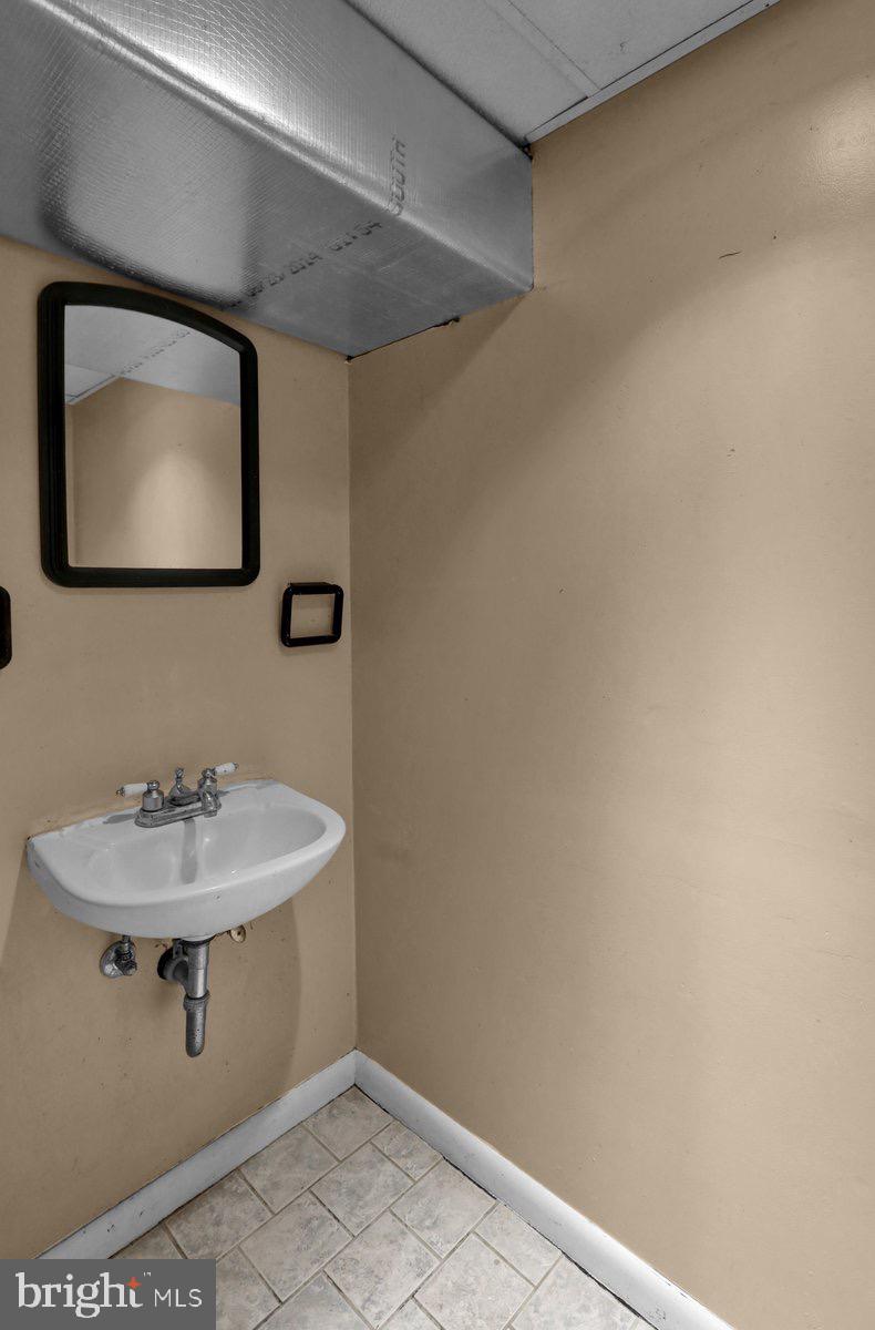 2326 Fairview Street Reading, PA 19609 - Photo 24 of 27 a bathroom with a sink and mirror