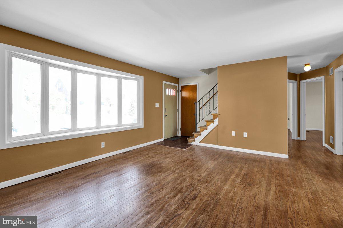 2326 Fairview Street Reading, PA 19609 - Photo 3 of 27 an empty room with wooden floor and windows