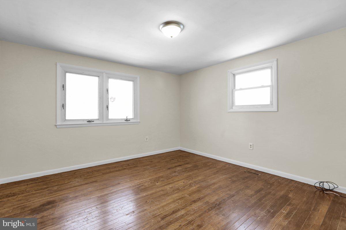 2326 Fairview Street Reading, PA 19609 - Photo 9 of 27 an empty room with wooden floor and windows