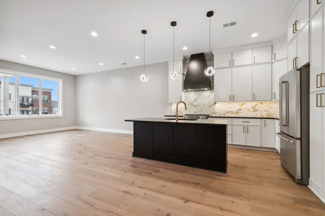 a kitchen with granite countertop a stove and a sink