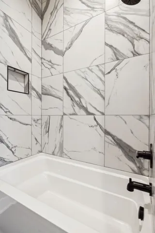 a kitchen with stainless steel appliances kitchen island granite countertop a refrigerator a sink and a stove