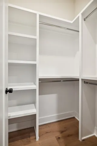 a kitchen with a stove and a wooden floor
