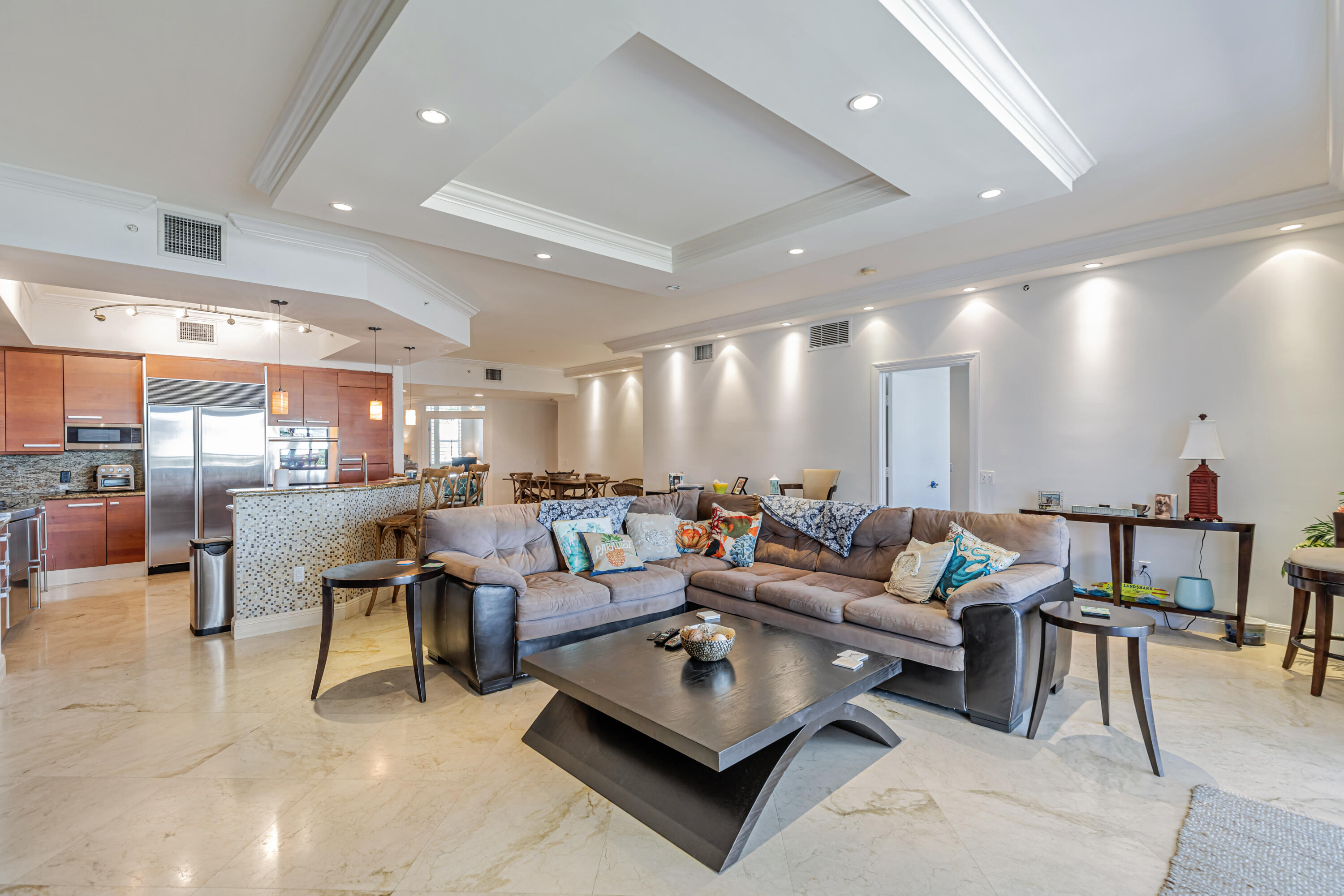 701 Southeast 21st Avenue, Unit 302 Deerfield Beach, FL 33441 - Photo 16 of 52 a living room with furniture rug and kitchen view
