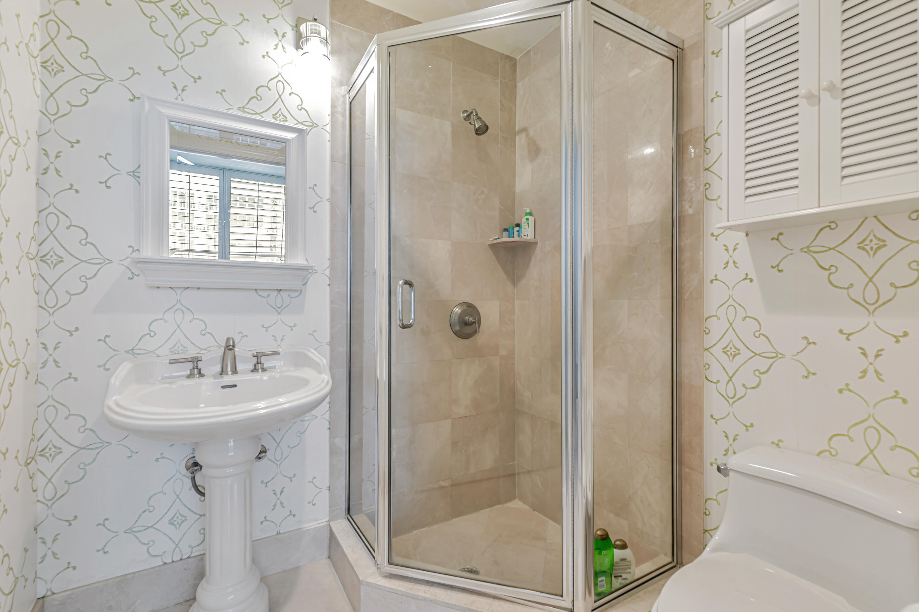 701 Southeast 21st Avenue, Unit 302 Deerfield Beach, FL 33441 - Photo 36 of 52 a bathroom with a sink a mirror and a shower