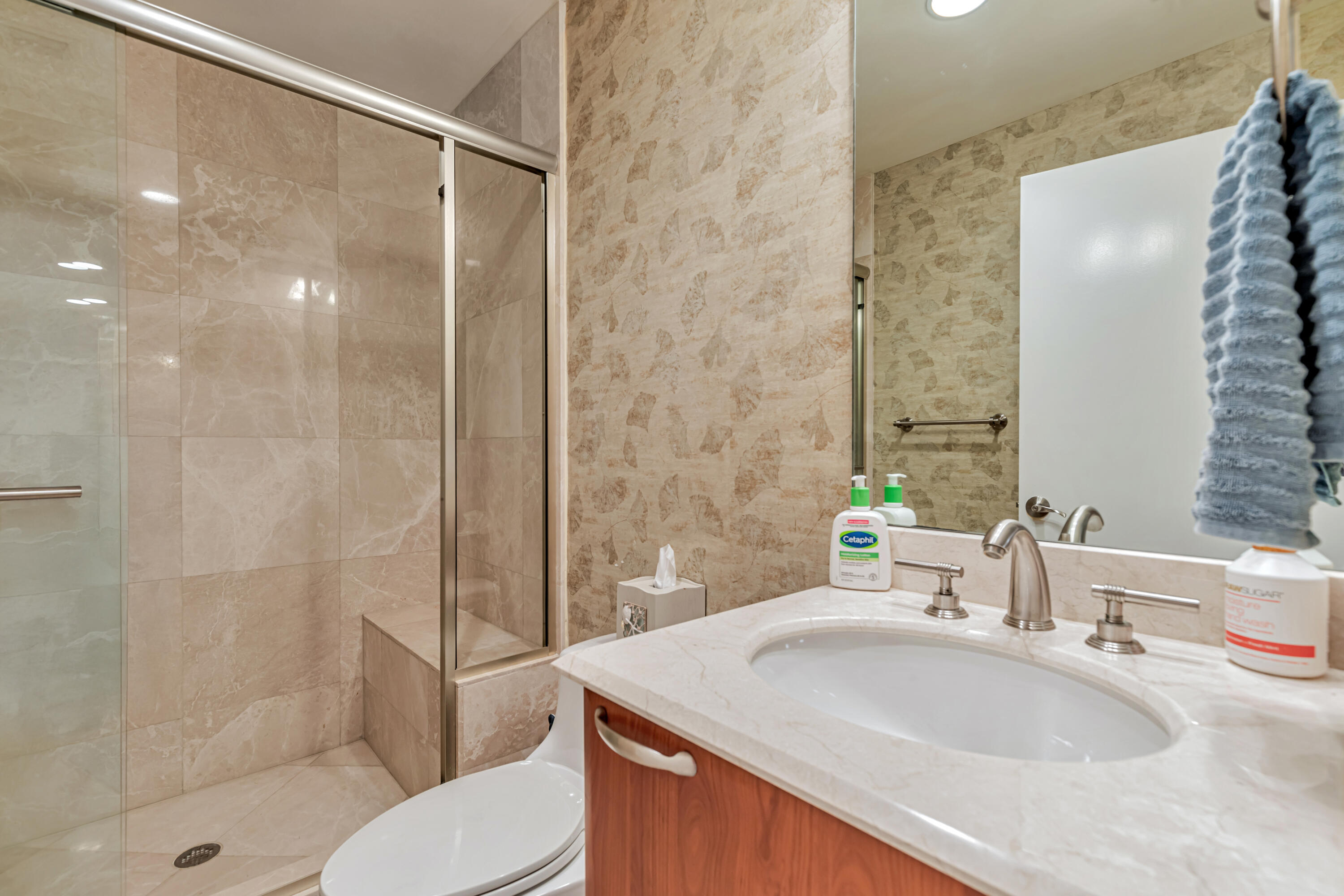 701 Southeast 21st Avenue, Unit 302 Deerfield Beach, FL 33441 - Photo 38 of 52 a bathroom with a sink toilet and shower