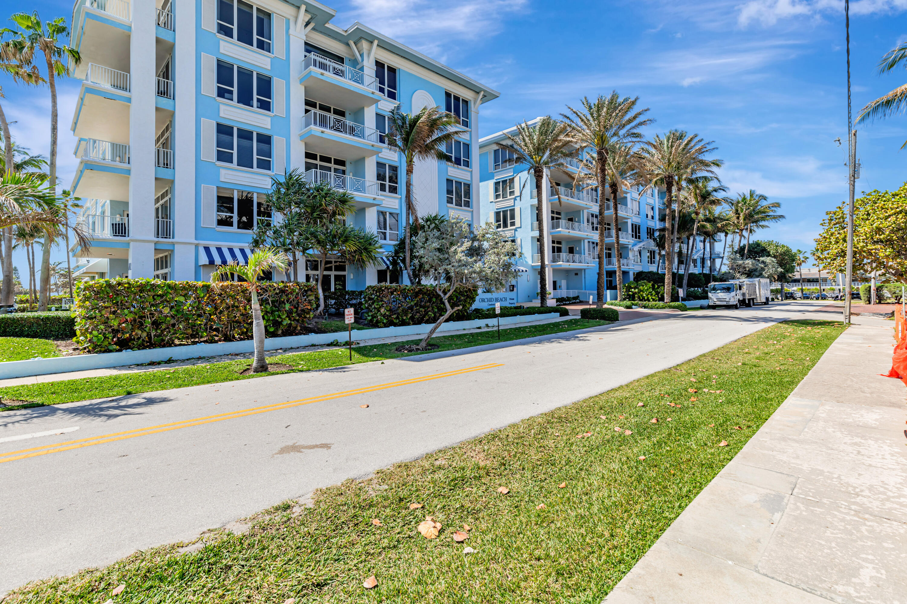 701 Southeast 21st Avenue, Unit 302 Deerfield Beach, FL 33441 - Photo 45 of 52 a multi story building with trees in front of it