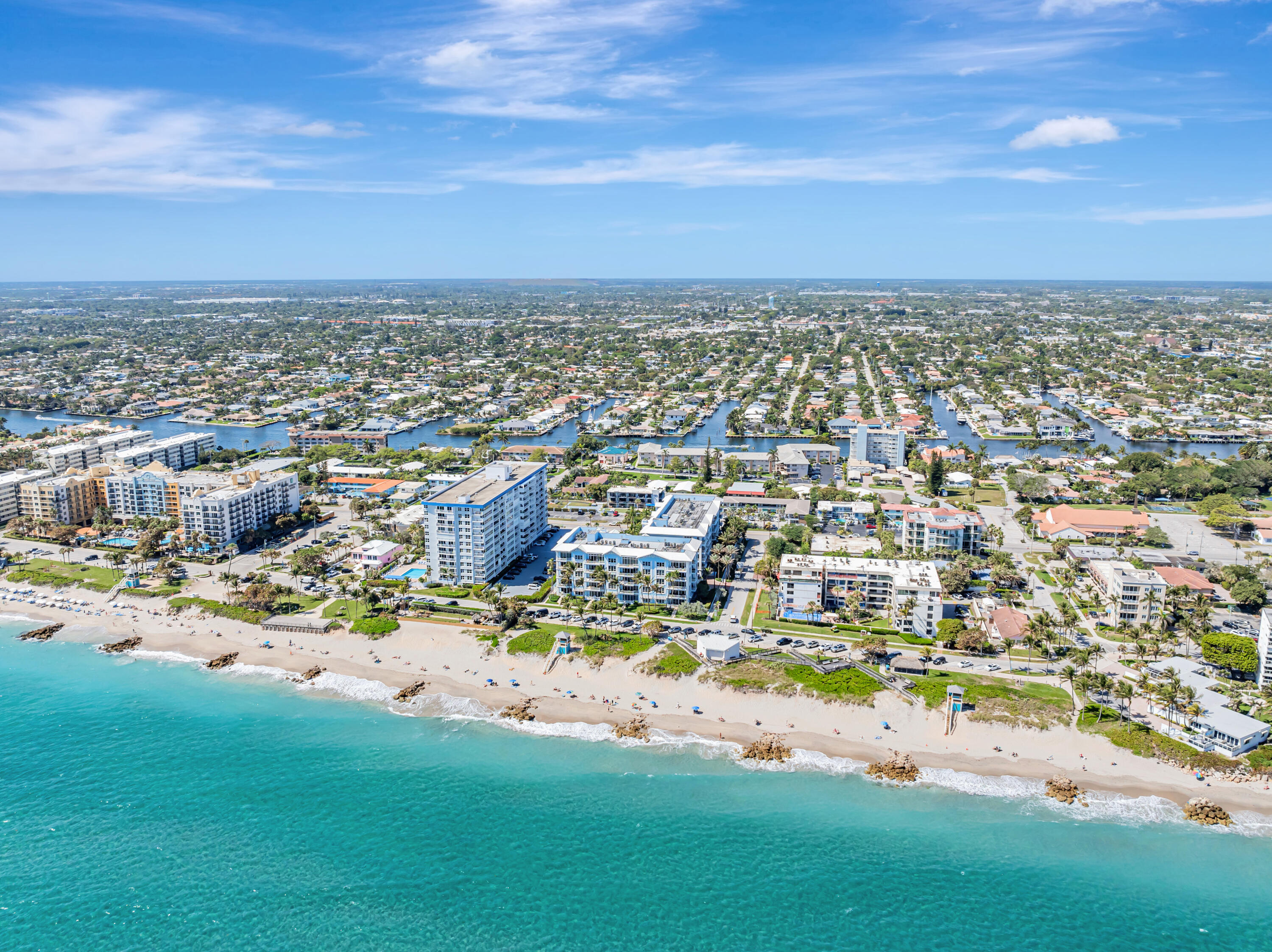 701 Southeast 21st Avenue, Unit 302 Deerfield Beach, FL 33441 - Photo 49 of 52 an aerial view of a city with lots of residential buildings ocean and mountain view in back