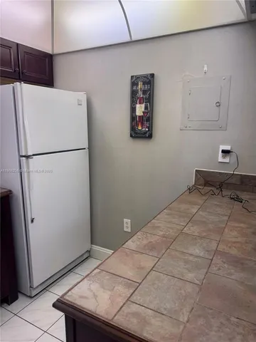 a refrigerator freezer sitting in a kitchen