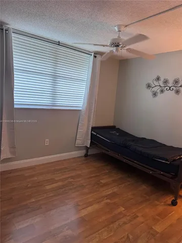 a view of room with window and a ceiling fan