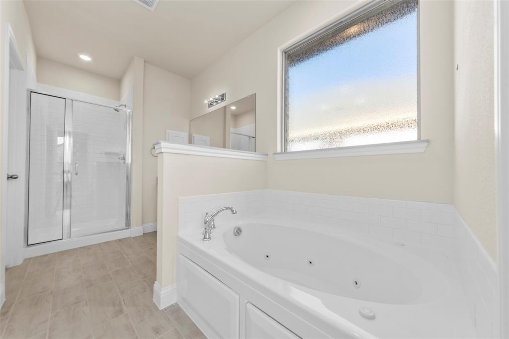 1529 Addison Lane Lancaster, TX 75134 - Photo 10 of 35 a white bath tub sitting in a bathroom