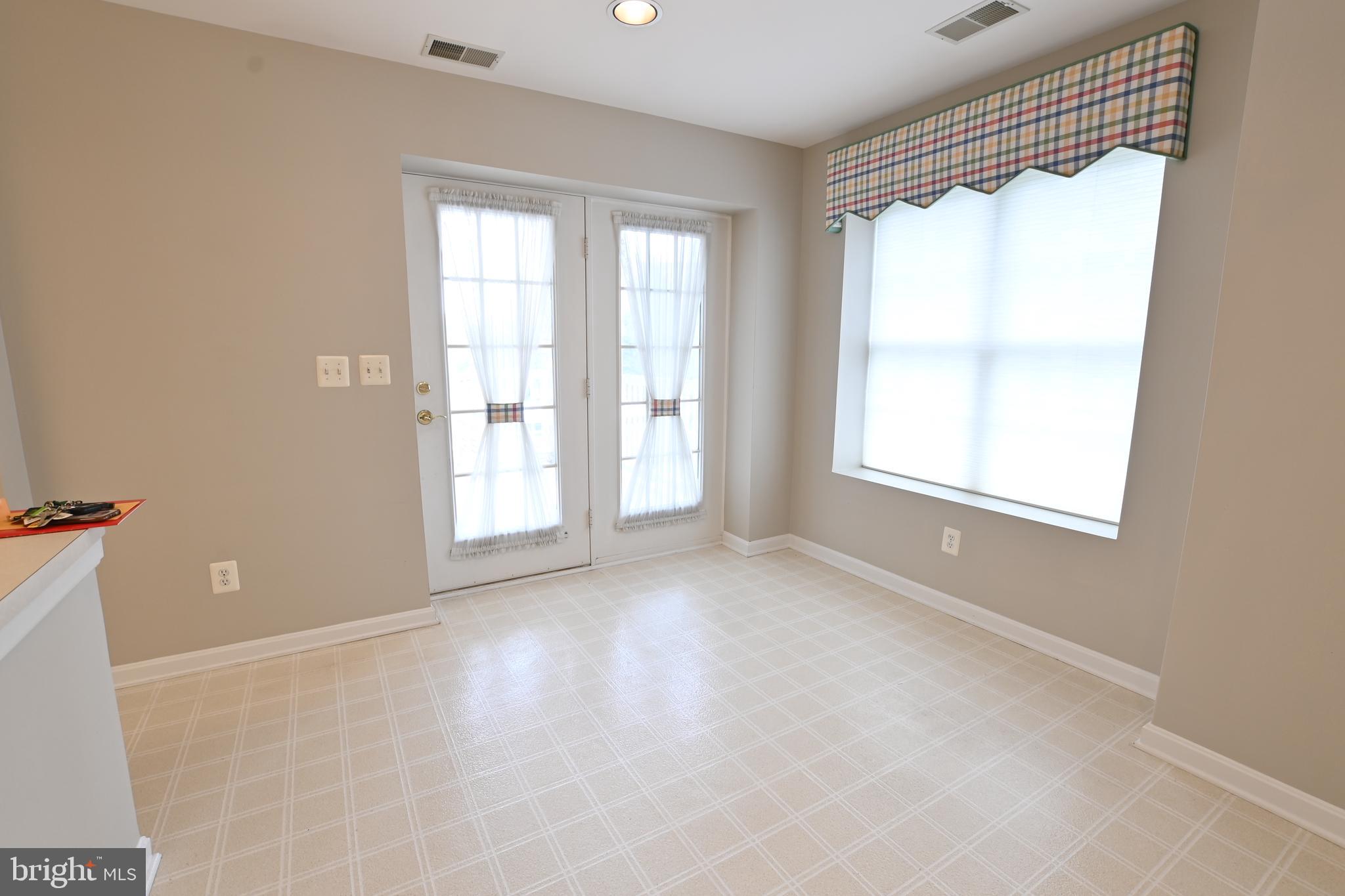 12300 Rosslare Ridge Road, Unit 301 Lutherville-Timonium, MD 21093 - Photo 14 of 25 Dining area to double atrium doors to balcony