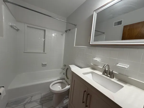 a bathroom with a sink a toilet and a bathtub