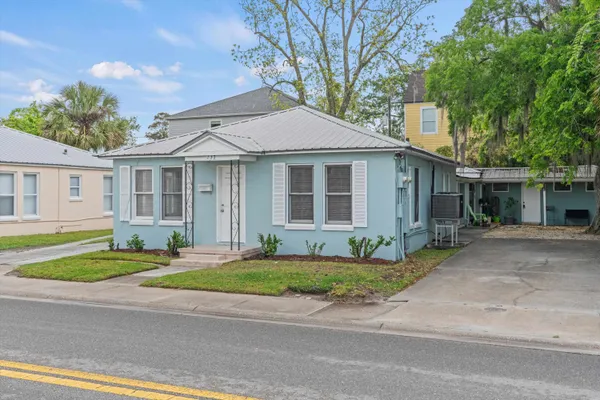 a front view of a house with a yard and a garage