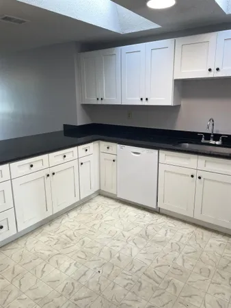 a kitchen with white cabinets