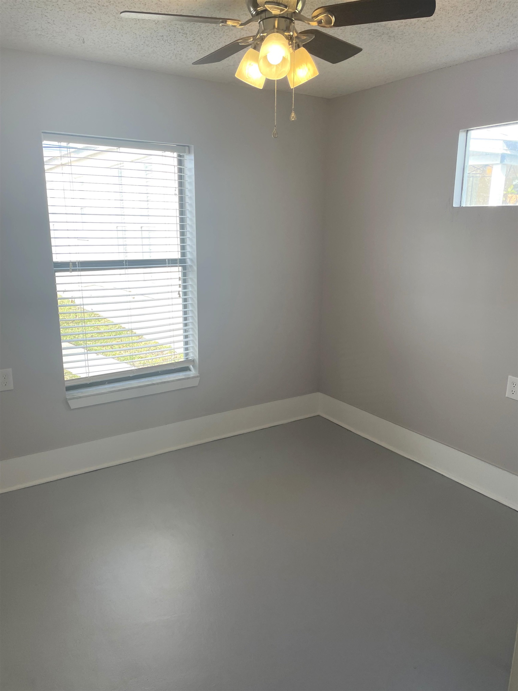 137.5 Riberia Street St. Augustine, FL 32084 - Photo 6 of 10 Unfurnished room featuring finished concrete flooring, a textured ceiling, and ceiling fan