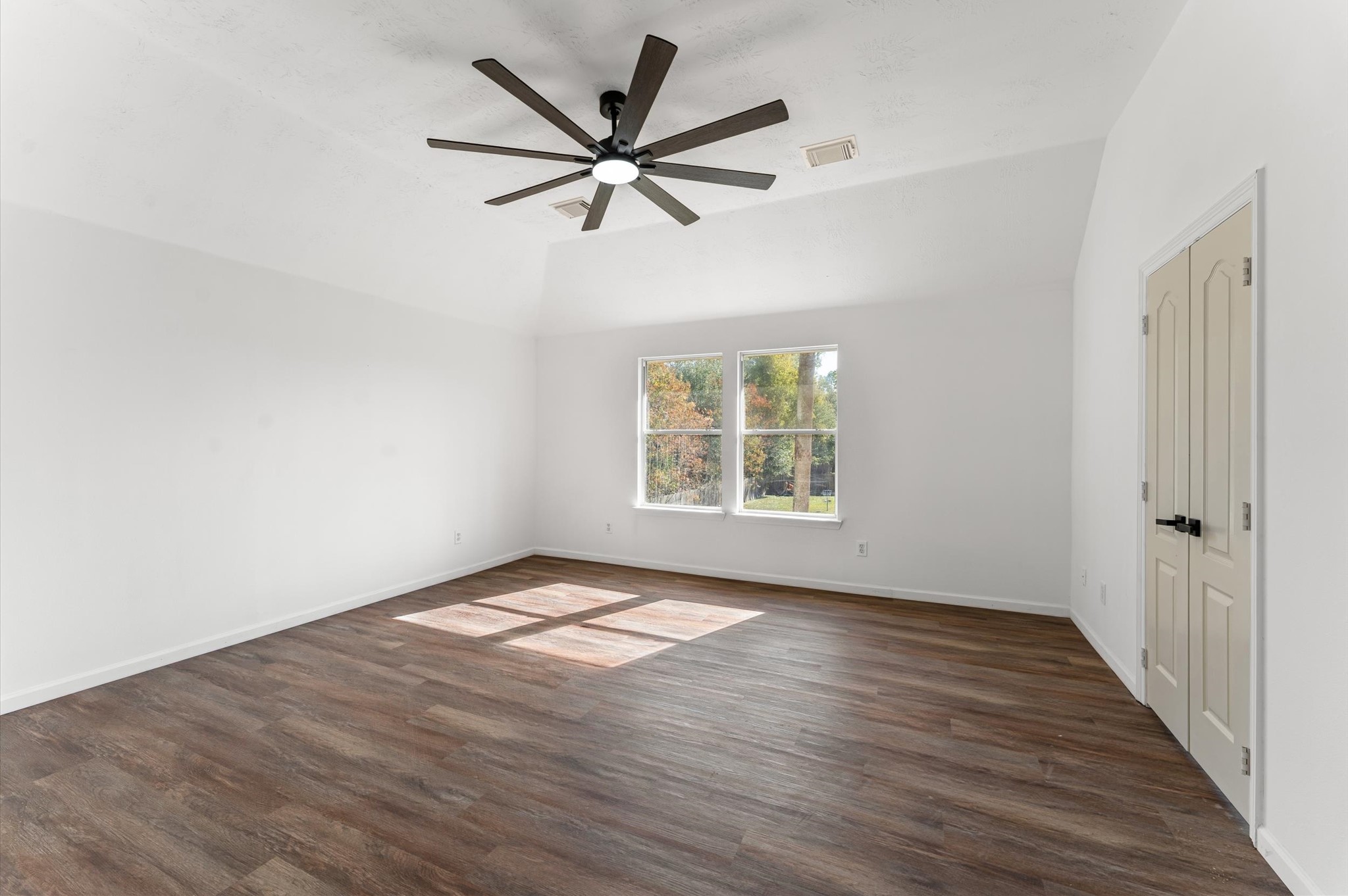 2830 Fern Hill Drive Spring, TX 77373 - Photo 23 of 39 an empty room with wooden floor fan and windows