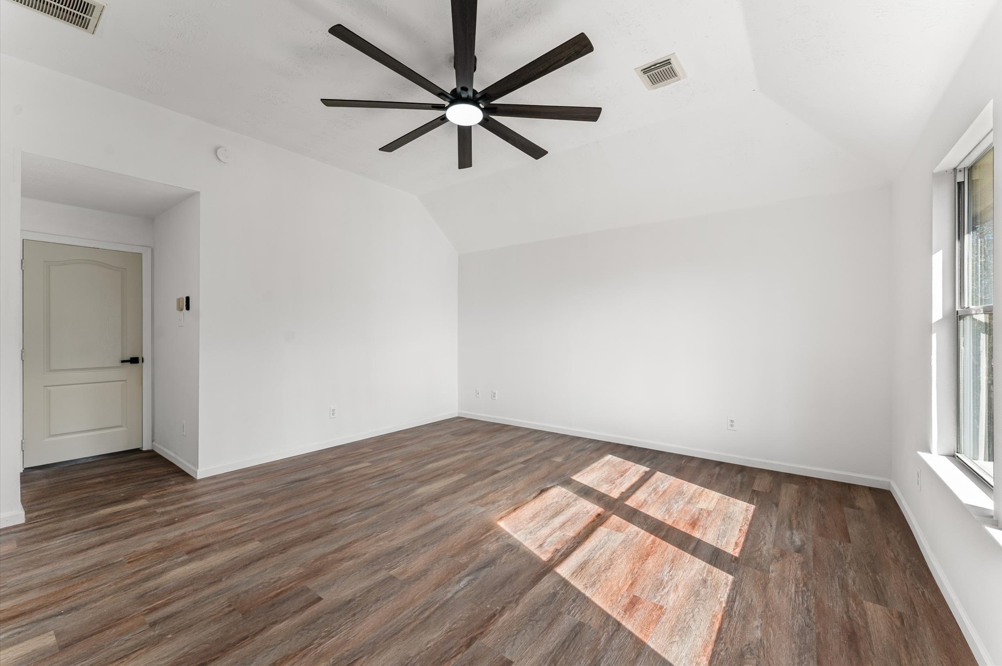 2830 Fern Hill Drive Spring, TX 77373 - Photo 24 of 39 an empty room with wooden floor fan and windows