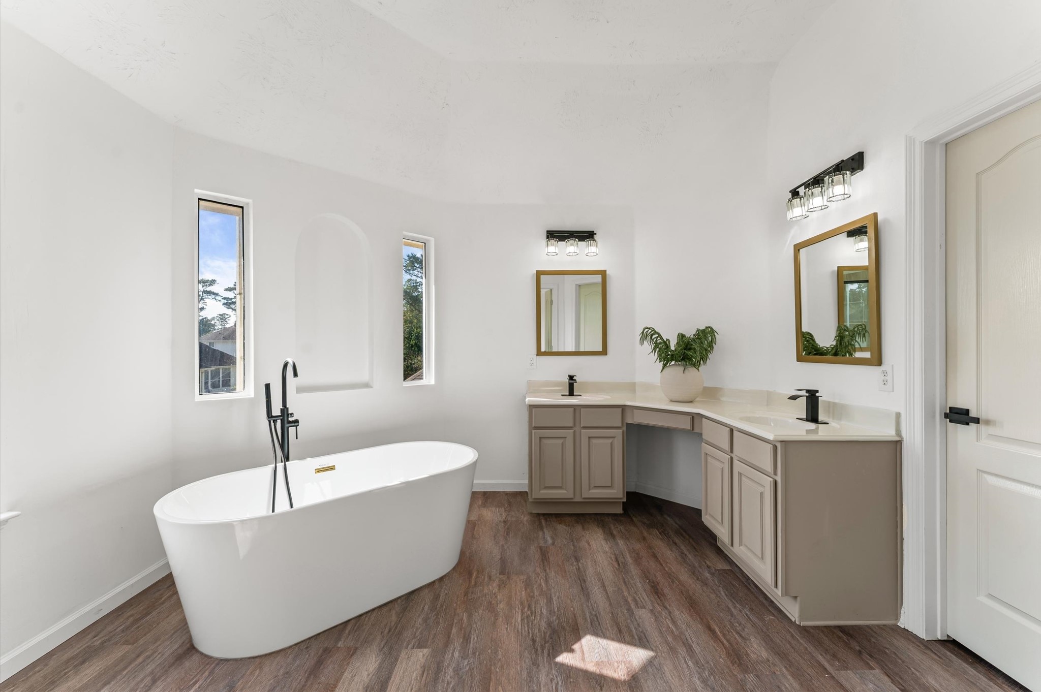2830 Fern Hill Drive Spring, TX 77373 - Photo 28 of 39 a bathroom with a white tub a vanity a sink and mirror
