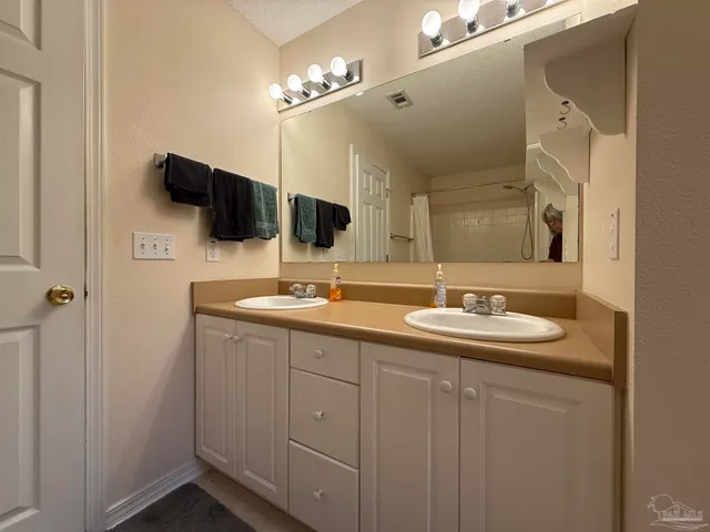a bathroom with a double vanity sink and mirror