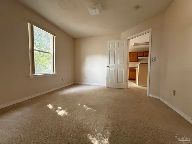 an empty room with windows and closet