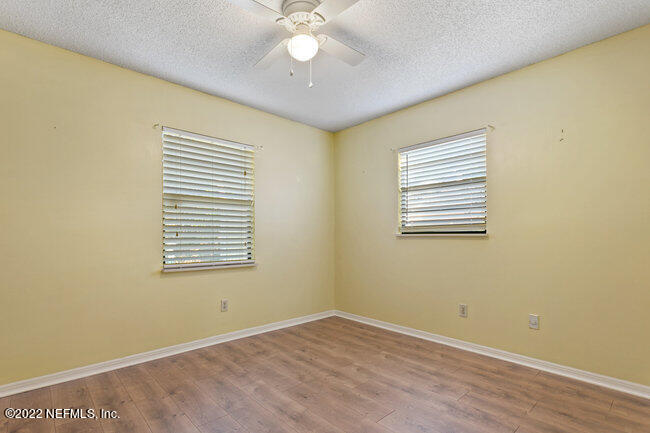 361 Shamrock Road St. Augustine, FL 32086 - Photo 16 of 30 a view of an empty room with wooden floor and a window